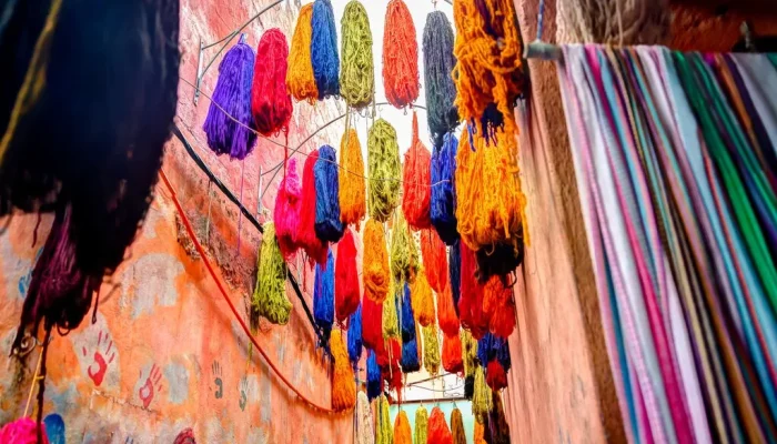 Browse the colorful textiles and fabrics found in the souks of Marrakesh