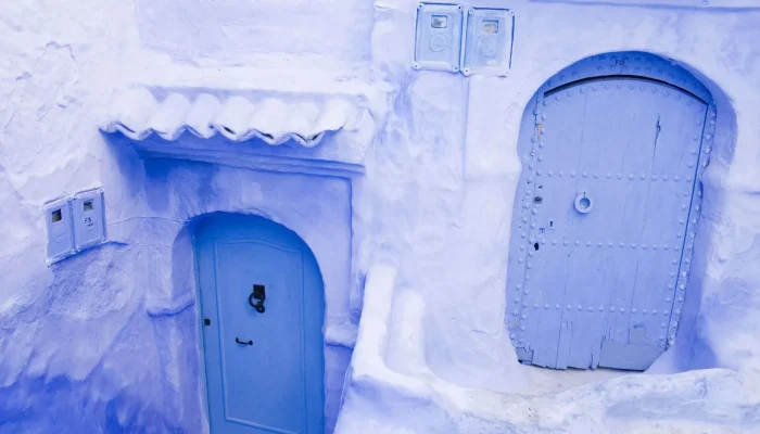 a blue building with doors and windows
